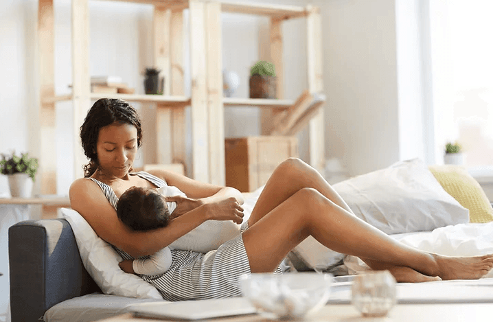 Mother laid back breastfeeding baby